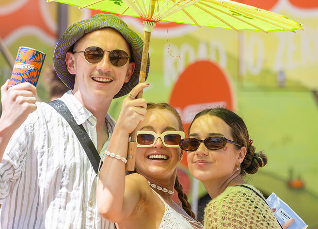 Three young people under sun umbrella